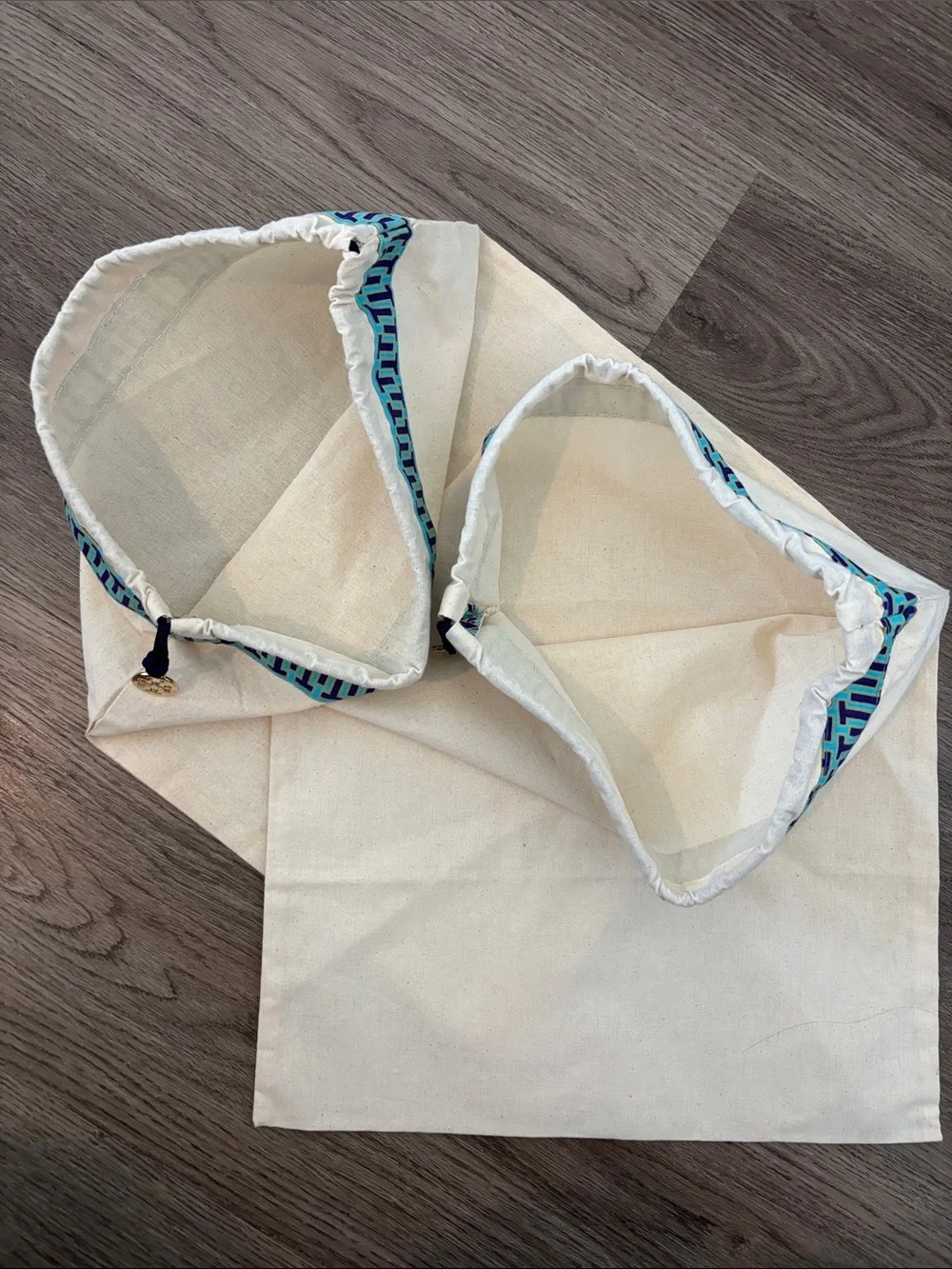 Set of 2 Tory Burch drawstring dust bags, canvas with gold charm